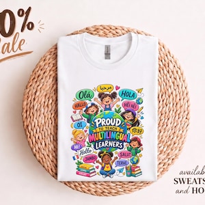 May include: A white t-shirt featuring a colorful graphic of a globe surrounded by diverse children and speech bubbles with greetings in various languages. The text reads Proud to Teach Multilingual Learners, with additional small books and globes.