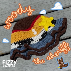 May include: Crocheted hat in the style of a sheriff's hat, featuring brown, yellow, red, white, black, and blue colors. The hat has a yellow star and a wavy brim. The word "Woody" is written on the top left, and "the sheriff" is written on the bottom right.