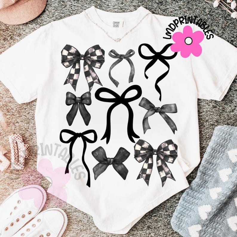 May include: White t-shirt featuring a collection of black bows in various styles. Some bows have a checkered pattern. The shirt also has the text "MDPrintables" and "INTAPRINTABLES" printed on it.