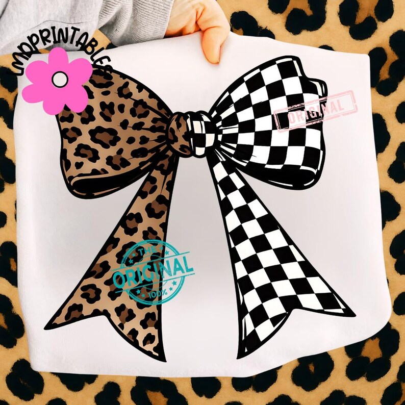 May include: A large bow design with a split pattern. One side features a leopard print in brown and black, while the other showcases a black and white checkered pattern. The design includes a pink flower and the word "ORIGINAL".