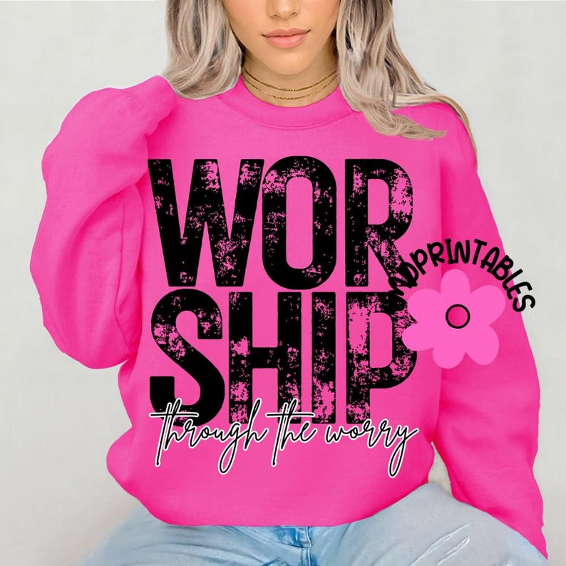 Pu&ograve; includere: Una felpa rosa acceso con la parola "WORSHIP" in grandi lettere nere consumate. Sotto, la frase "through the worry" &egrave; scritta in corsivo. Una grafica floreale rosa con la parola "PRINTABLES" &egrave; a destra.