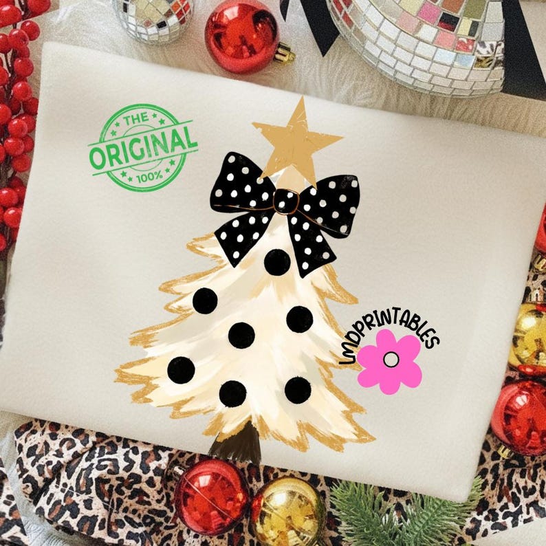 May include: Cream-colored Christmas tree design with a black polka dot bow and black polka dots. The tree has a gold star and trunk. The words "THE ORIGINAL 100%" are printed in green. The word "LNDPRINTABLES" is printed in black with a pink flower.
