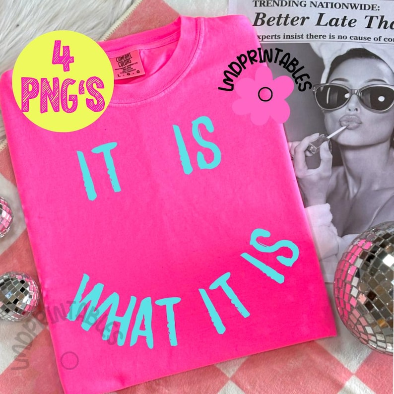 May include: A bright pink t-shirt with the phrase "IT IS WHAT IT IS" in turquoise lettering. The shirt also has a yellow circle with the text "4 PNG'S". The image includes a disco ball and a magazine clipping.