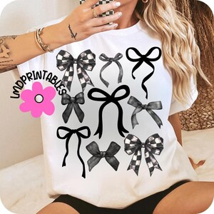 May include: White t-shirt featuring a collection of black and white bows in various styles. Some bows have a checkered pattern, while others are solid black. The shirt also has the text "mdprintables" and a pink flower graphic.