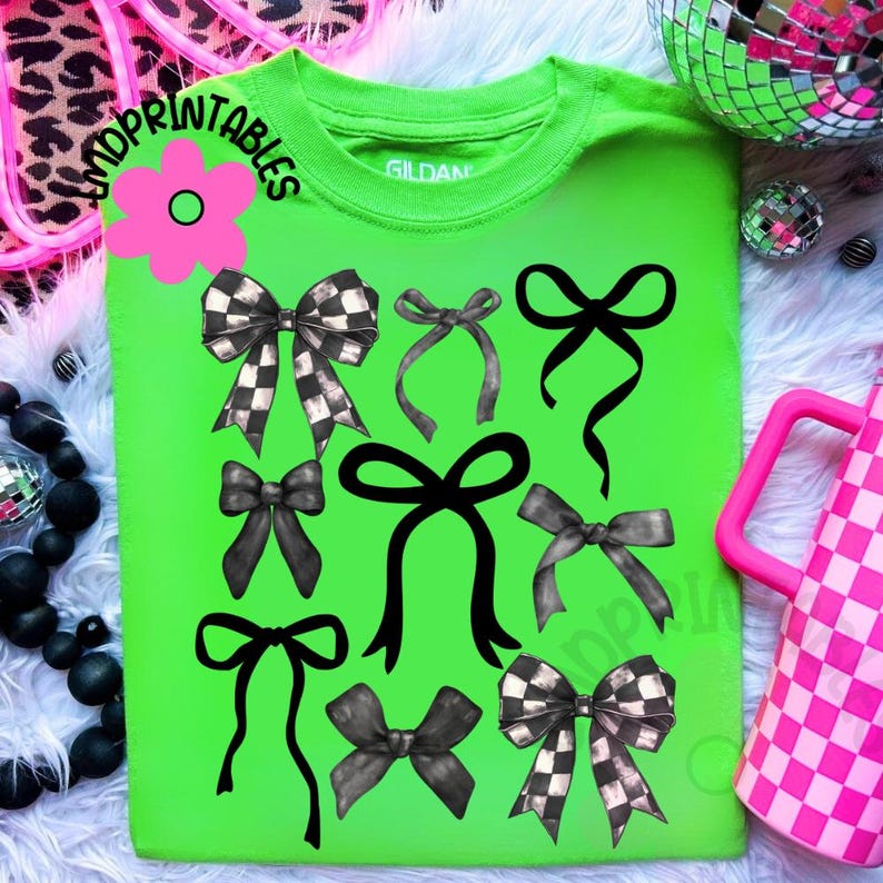 May include: A neon green t-shirt featuring a collection of black and gray bows in various styles. Some bows have a checkered pattern. The shirt also has the text "SHOPPRINTABLES" in a circular design with a pink flower.