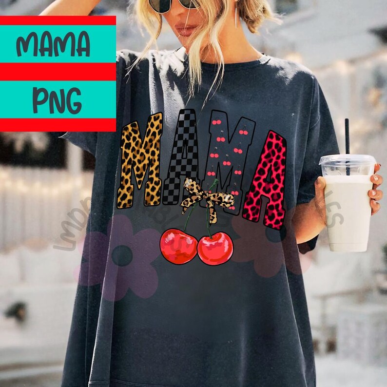 May include: Dark gray t-shirt with the word "MAMA" in leopard print, checkered, and pink leopard print letters. A bow and two red cherries are below the word. The shirt is a casual style.