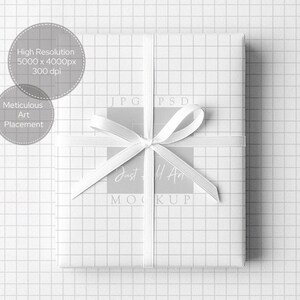 May include: A wrapped gift box with white grid paper and a white ribbon tied in a bow. The gift box is centered on a white grid background. Text on the image includes "High Resolution 5000 x 4000px 300 dpi" and "Meticulous Art Placement."