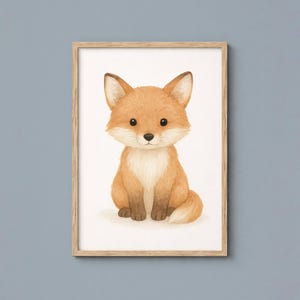 May include: A framed watercolor print of a cute fox. The fox has orange and white fur, large black eyes, and is sitting upright. The artwork is in a light brown wooden frame, perfect for a nursery or children's room.
