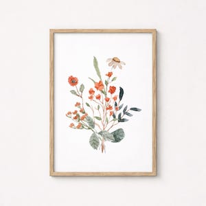 May include: Watercolor painting of a floral bouquet in a wooden frame. The artwork features orange and red flowers, green leaves, and a single daisy. The painting is on white paper.