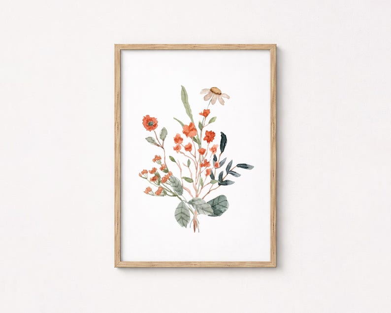 May include: Watercolor painting of a floral bouquet in a wooden frame. The artwork features orange and red flowers, green leaves, and a single daisy. The painting is on white paper.