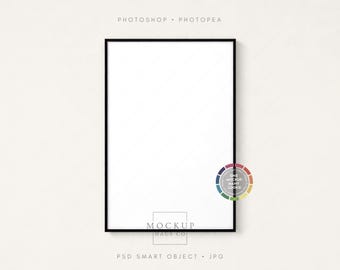 May include: A black framed rectangular mockup with a white interior, hanging on a light beige wall. The text "PHOTOSHOP • PHOTOPEA" is at the top, and "MOCKUP HAUS CO" is at the bottom. A color wheel is on the right side.