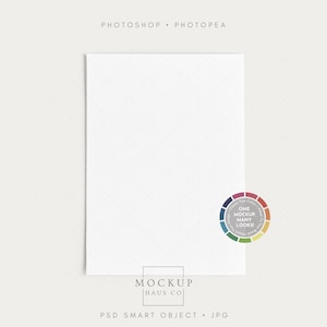 May include: A white rectangular mockup with a subtle diamond pattern. The image includes text at the top and bottom, along with a color wheel graphic. The text reads "PHOTOSHOP • PHOTOPEA" and "MOCKUP HAUS CO".