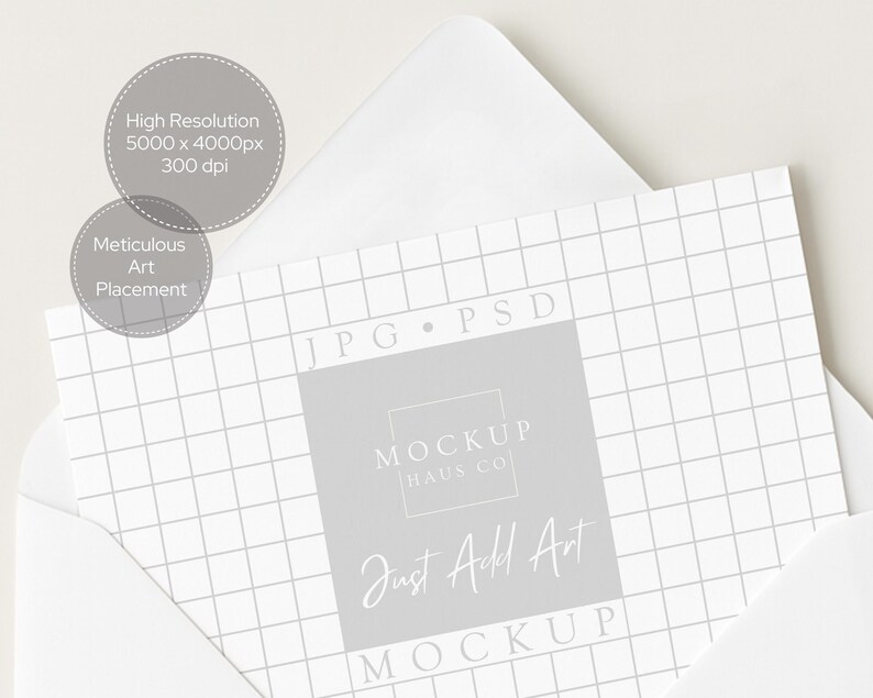 May include: A white envelope partially open, revealing a grid-patterned card with the text "MOCKUP HAUS CO" and "Just Add Art". The card is light gray with a grid pattern. Two gray circles with text are in the upper left.