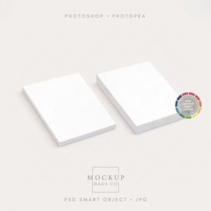 May include: Two stacks of white rectangular paper, slightly angled, on a light background. The top of each stack is visible, showing the clean, white surface. A color wheel and the text "Photoshop Photopea" are in the image.