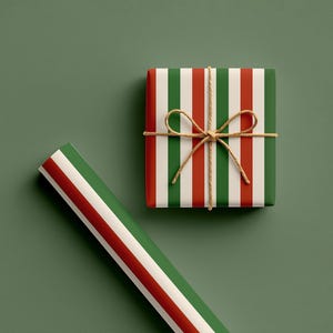 May include: A wrapped gift box and a roll of wrapping paper with red, white, and green vertical stripes. The gift is tied with twine and a bow. The background is a muted green.