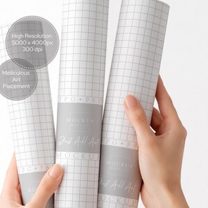 May include: Three rolled-up white paper mockups with a grid pattern are held by a person. The paper has a gray band with the text "MOCKUP HAVE CO" and "Just All Art". The image also includes text that says "High Resolution 5000 x 4000px 300 dpi" and "Meticulous Art Placement."