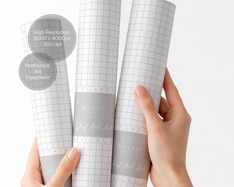May include: Three rolled-up white paper mockups with a grid pattern are held by a person. The paper has a gray band with the text "MOCKUP HAVE CO" and "Just All Art". The image also includes text that says "High Resolution 5000 x 4000px 300 dpi" and "Meticulous Art Placement."