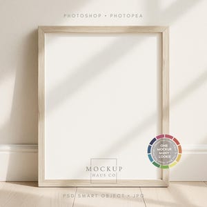 May include: A rectangular wooden picture frame with a white interior, leaning against a wall. The frame is light brown and has a simple design. The text "MOCKUP HAUS CO" is visible at the bottom. The text "PSD SMART OBJECT • JPG" is also visible.