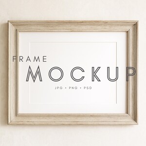 May include: A rectangular wooden frame mockup with a white mount. The frame is light brown with visible wood grain. The text "FRAME MOCKUP" is centered in the frame, with "JPG • PNG • PSD" below it.