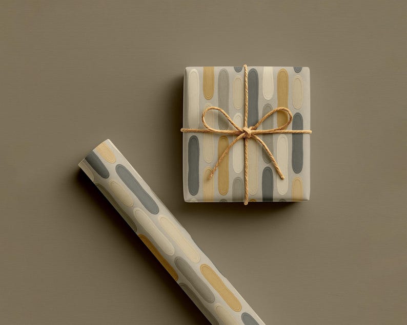 May include: A wrapped gift box and a roll of wrapping paper. The gift box is wrapped in paper with a pattern of vertical ovals in grey, yellow, and cream. The box is tied with twine. The roll of paper has the same pattern.