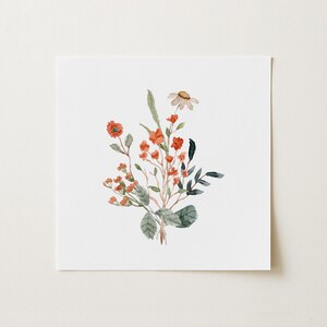 May include: Watercolor painting of a floral bouquet. The arrangement features orange and red flowers, green leaves, and a single daisy. The artwork is set against a white background, creating a soft and natural aesthetic. The style is delicate and botanical.