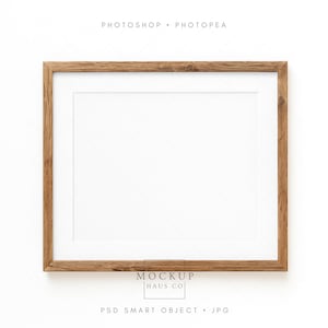 May include: A rectangular wooden picture frame with a white mat. The frame is made of light brown wood and has a natural, rustic appearance. The words "Photoshop Photopae" are at the top, and "Mockup Haus Co" and "PSD Smart Object JPG" are at the bottom.