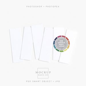 May include: A flat lay featuring several white rectangular cards arranged on a white surface. One card has a colorful circular design with the text "ONE MOCKUP MANY LOOKS". The words "PHOTOSHOP" and "PHOTPEA" are at the top.