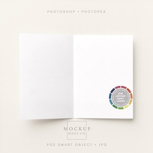 May include: An open, white greeting card mockup with a diamond pattern on the inside. The card has a color wheel graphic on the bottom right corner. The text "PHOTOSHOP • PHOTOPEA" is at the top, and "MOCKUP HAUS CO" is at the bottom.