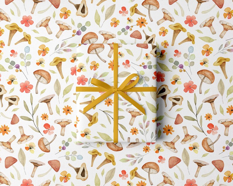 May include: White wrapping paper with a repeating pattern of watercolor mushrooms, flowers, and leaves. A wrapped gift is tied with a yellow ribbon. The design features orange, yellow, and brown tones.
