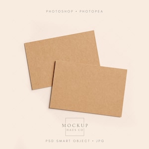 May include: Two rectangular kraft paper cards arranged on a light beige background. The cards are a warm brown color. The image includes the text "PHOTOSHOP • PHOTOPEA" at the top and "MOCKUP HAUS CO" and "PSD SMART OBJECT • JPG" at the bottom.