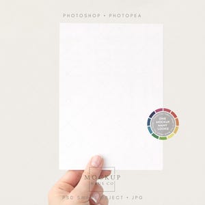 May include: A white rectangular card held by a hand, with a subtle diamond pattern. The card has the text "PHOTOSHOP • PHOTOPAE" at the top and a color wheel with the text "ONE MOCKUP MANY LOOKS!" on the right. The bottom of the card has the text "MOCKUP HAUS CO" and "PSD SMART OBJECT • JPG".