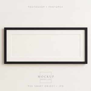 May include: A rectangular black picture frame with a white mat. The frame is mounted on a light-colored wall. The words "PHOTOSHOP • PHOTOPEA" are at the top, and "MOCKUP HAUS CO" and "PSD SMART OBJECT • JPG" are at the bottom.