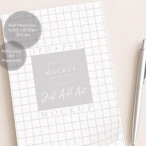 May include: A white grid-patterned mockup with the text "MOCKUP HAUS CO" and "Just Add Art". A silver pen rests on a light beige surface. The image also includes text that says "High Resolution 5000 x 4000px 300 dpi" and "Meticulous Art Placement".