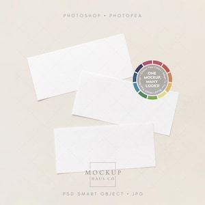 May include: Three white rectangular cards on a light beige surface. A colour wheel graphic with the text "ONE MOCKUP, MANY LOOKS!" is visible. The cards have a subtle diamond pattern. The words "PHOTOSHOP" and "PHOTOPEA" are at the top.