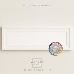 May include: A white rectangular picture frame with a white border, mounted on a light beige wall. The frame has a large, empty space for an image or artwork. A color wheel graphic is in the lower right corner, with the text "ONE MOCKUP, MANY LOOKS!"