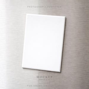 May include: A blank white canvas on a silver background. The canvas is rectangular and centered, with the words "PHOTOSHOP • PHOTOREA" at the top and "MOCKUP HAUS CO" and "PSD SMART OBJECT" at the bottom.
