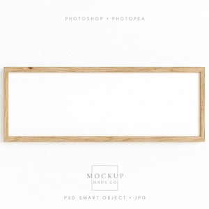 May include: A rectangular wooden frame with a white interior, suitable for displaying artwork or photos. The frame has a natural wood grain finish and is set against a white background. The text "PHOTOSHOP • PHOTOPAE" is at the top, and "MOCKUP HAUS CO" and "PSD SMART OBJECT • JPG" are at the bottom.