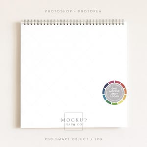 May include: A white spiral-bound notepad with a diamond pattern on the pages. The notepad has a silver metal binding and a circular sticker with the text "ONE MOCKUP MANY LOOKS". The words "PHOTOSHOP" and "PHOTOPAE" are at the top.