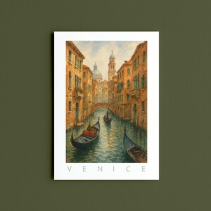 May include: Watercolor print of Venice, Italy, featuring a canal with gondolas, buildings, and a bridge. The artwork has warm tones of orange, yellow, and blue. The word "VENICE" is printed in white at the bottom of the image.