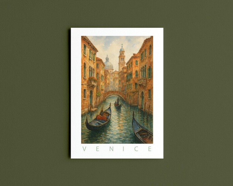 May include: Watercolor print of Venice, Italy, featuring a canal with gondolas, buildings, and a bridge. The artwork has warm tones of orange, yellow, and blue. The word "VENICE" is printed in white at the bottom of the image.