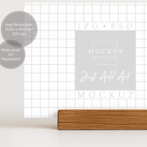 May include: A mockup featuring a white grid background with text that reads "Just Add Art" and "Mockup". A wooden block is at the bottom. The image also includes text that says "High Resolution" and "Meticulous Art Placement".