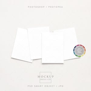 May include: A mockup image featuring four white rectangular cards arranged on a light background. The cards are slightly angled, creating a sense of depth. A color wheel and the text "MOCKUP HAUS CO" are also visible.