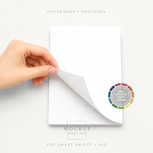 May include: A white notepad with a corner of a page being lifted by a hand. The notepad has a subtle diamond pattern. The image includes the text "PHOTOSHOP • PHOTOPEA" and "ONE MOCKUP MANY LOOKS".