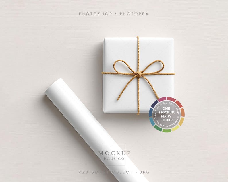 May include: A white square gift box tied with twine, beside a rolled-up white paper. A colour wheel with the text "ONE MOCKUP, MANY LOOKS!" is also present. The words "MOCKUP HAUS CO" and "PSD SMART OBJECT . JPG" are visible.