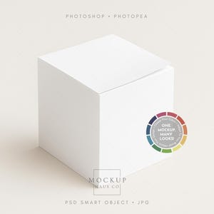 May include: A white cube with a slightly open top, set against a neutral background. The image includes text that reads "Photoshop Photopea" and a color wheel graphic with the text "One Mockup, Many Looks!" and "Mockup Haus Co."