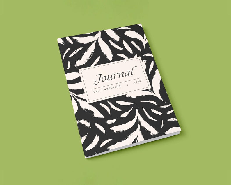 May include: A closed journal with a black and white abstract leaf pattern. The journal has a rectangular label with the word "Journal" and the year "2020". The words "Daily Notebook" are also printed on the label.