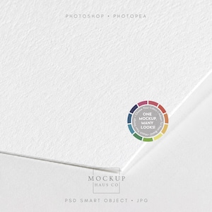 May include: A white textured paper mockup with a corner folded over. The image features the text PHOTOSHOP &bull; PHOTOPEA at the top, a circular color wheel graphic with the text ONE MOCKUP. MANY LOOKS!, and MOCKUP HAUS CO PSD SMART OBJECT &bull; JPG at the bottom.