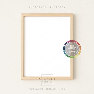 May include: A rectangular wooden picture frame with a white interior, set against a neutral background. The frame has a natural wood finish. Text on the image includes "PHOTOSHOP", "PHOTPEA", "ONE MOCKUP MANY LOOKS!", "MOCKUP HAUS CO", "PSD SMART OBJECT", and "JPG".