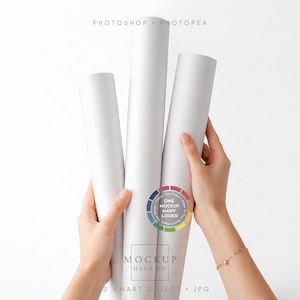 May include: Three white rolled paper tubes held by hands against a white background. The image includes the text "PHOTOSHOP PHOTOPAE" at the top and a circular logo with the text "ONE MOCKUP MANY LOOKS!" and "MOCKUP HAUS CO" at the bottom.