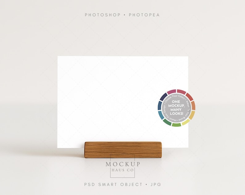 May include: A white rectangular card is held by a rectangular wooden holder. A color wheel graphic with the text "ONE MOCKUP. MANY LOOKS!" is on the right. The text "MOCKUP HAUS CO" and "PSD SMART OBJECT . JPG" are at the bottom.